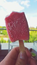 Cropped hand holding ice cream cone