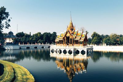 Lake by bang pa-in royal palace against sky