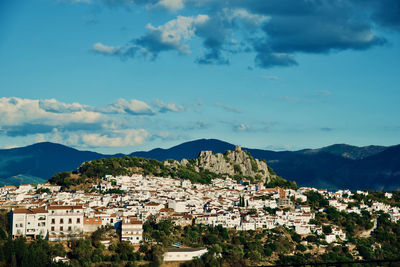 Townscape by mountains against sky