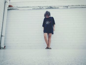 Portrait of young woman standing on ground