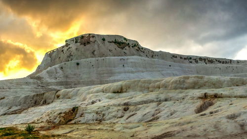 Scenic view of snowcapped mountains against sky during sunset