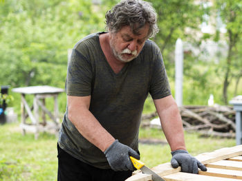 Full length of man working in yard