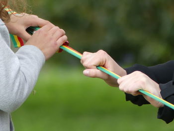 Close-up of women holding cable