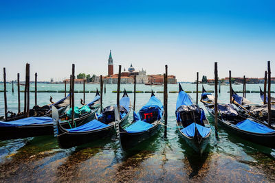 Gondolas moored at grand canal in city