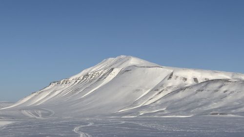 Scenic view of snowcapped mountains against clear blue sky - svalbard 