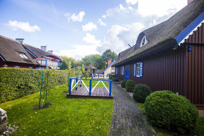 Houses and trees against sky