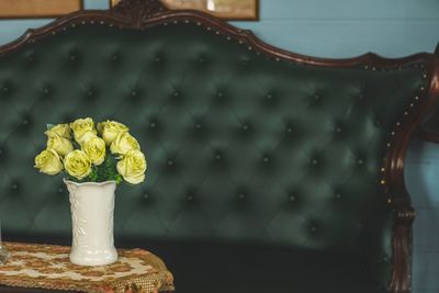 Close-up of yellow rose in vase on table