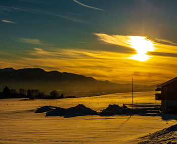 Scenic view of snowcapped mountains against sky during sunset