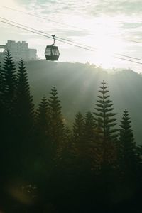 High section of overhead cable car over sea against sky