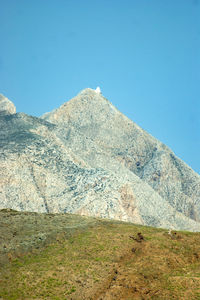 Scenic view of mountains against clear blue sky