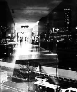 Illuminated buildings seen through wet glass window at night