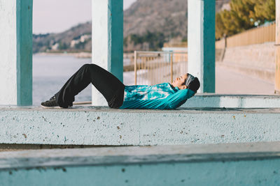 Side view portrait of young woman sleeping outdoors