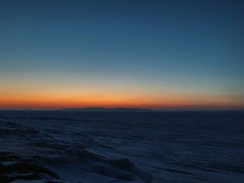 Scenic view of sea against clear sky during sunset