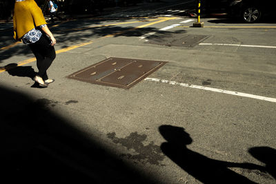 Rear view of a woman walking on road