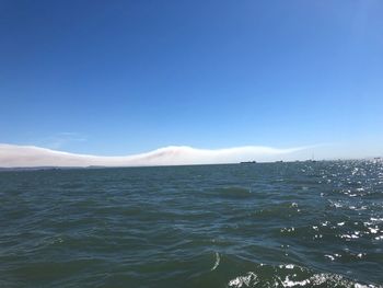 Scenic view of sea against clear blue sky