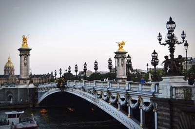 Bridge over river with city in background