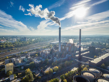 Smoke emitting from industry against sky