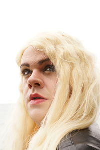 Close-up of transgender male in wig looking away