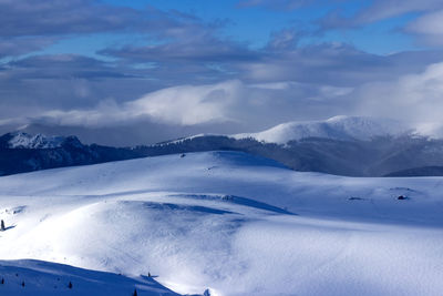 Scenic view of snow covered mountains against sky