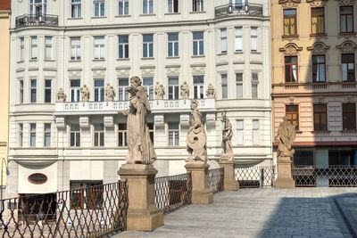 Statue against building in city