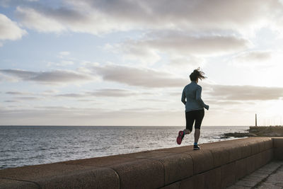 Woman running with the sky