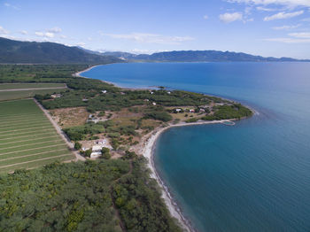 High angle view of sea and mountains against sky