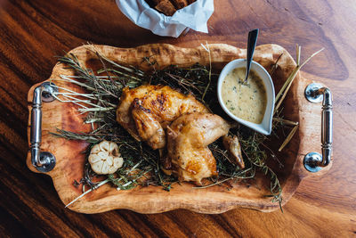High angle view of chicken with dip served on table