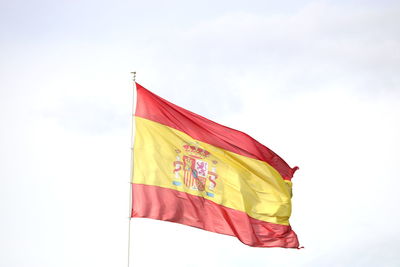 Low angle view of flag flags against sky