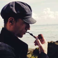 Side view of man smoking pipe