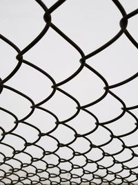 Full frame shot of chainlink fence against sky