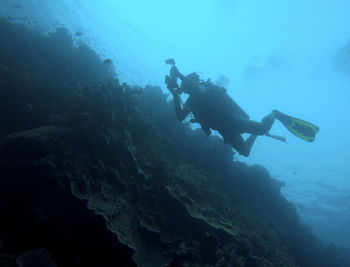 Low angle view of man swimming in sea