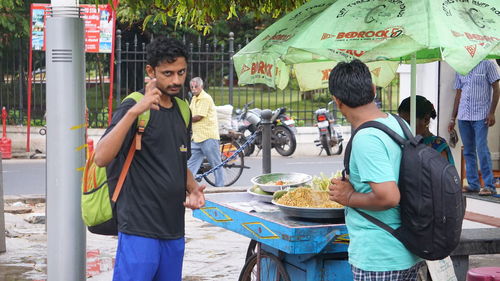 Young man holding food at market
