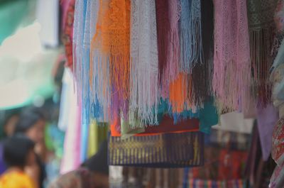 Close-up of multi colored scarfs hanging for sale