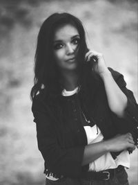 Portrait of beautiful young woman standing outdoors