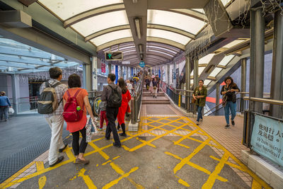 People walking on railway station platform