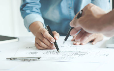 Close-up of people working on table