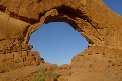 Low angle view of rock formation against blue sky