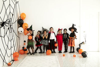 High angle view of people standing on street against wall during halloween