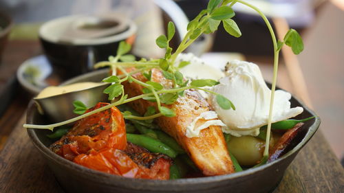 Close-up of fish with vegetables served on table