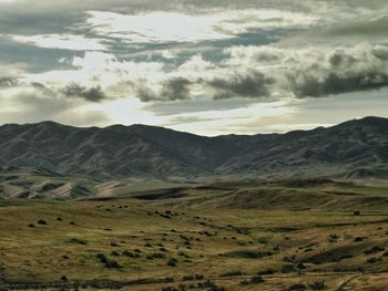 Scenic view of mountains against cloudy sky