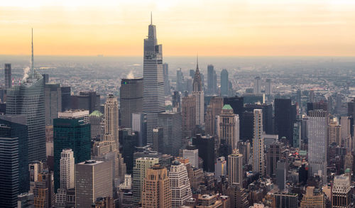 Aerial view of city buildings during sunset