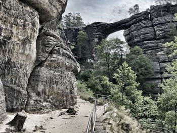 Low angle view of rock formation on mountain against sky