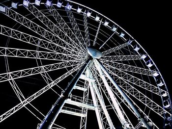 Low angle view of ferris wheel at night