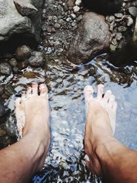 Close-up low section of person in lake