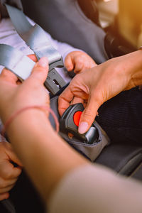 Cropped hands of man repairing car