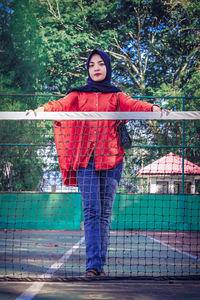 Portrait of girl standing against tree