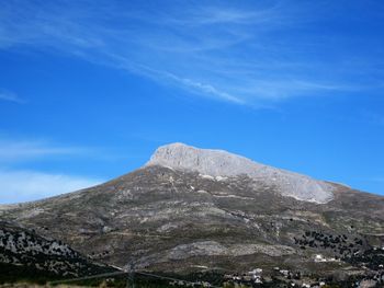 Low angle view of mountain against blue sky