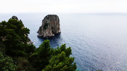 Faraglioni capri - rocks on sea shore against sky