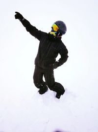 Man standing on snow against white background