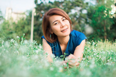 Portrait of woman resting on field